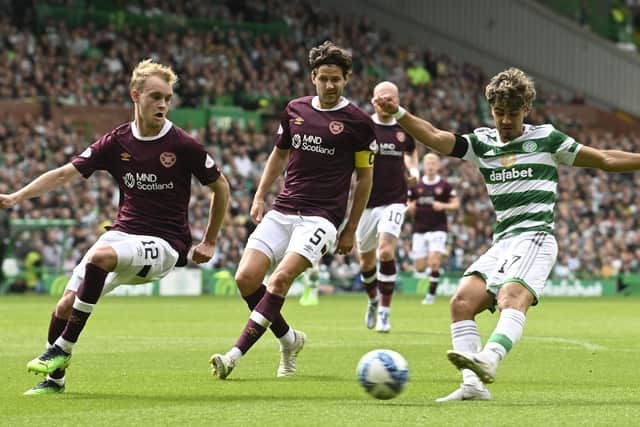 Celtic winger Jota takes on Hearts defender Nathaniel Atkinson at Celtic Park.