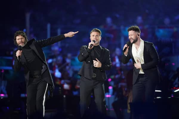 Howard Donald and Gary Barlow of Take That, perform with Callum Scott (right) on stage during the Coronation Concert