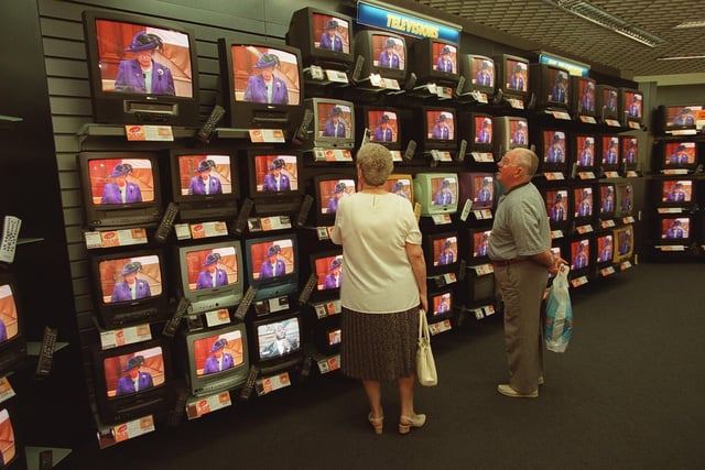 TVs in the Comet store during the live broadcast of the Queen opening the Scottish Parliament.
