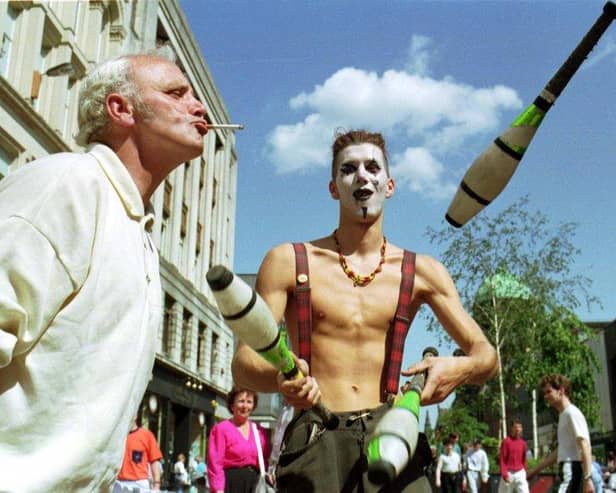 A street entertainer juggling in Argyle Street on a sunny Glasgow day in June 1992.