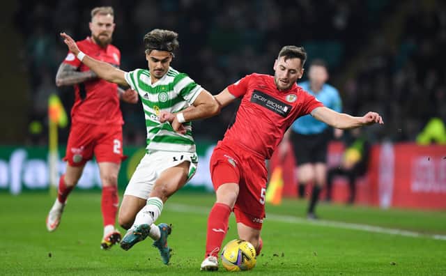 Celtic's Jota and St Mirren's Connor McCarthy battle for possession. (Photo by Ross MacDonald / SNS Group)