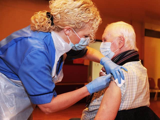 18-01-2021. Picture Michael Gillen. FALKIRK. Day 298 of UK wide coronavirus lockdown measures. Day 14 of mainland Scotland Lockdown Two. Falkirk is in Level 4. FALKIRK. Falkirk Town Hall. NHS Forth Valley, Community covid vaccination clinic starts today. Pfizer-BioNTech Covid-19 vaccine being used today. Tracey McGregor, immunisation staff nurse and John Shepherd 82 from Camelon.