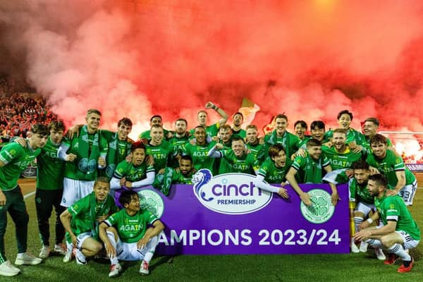 The Celtic squad celebrate in front of the visiting fans after clinching the title at Rugby Park.