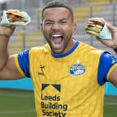 First men’s team captain of the Leeds Rhinos, Kruise Leeming, ‘try-s and tastes’ new Deliveroo x Hooyah Burgers exclusive Leeds Rhinos burger ahead of its launch on National Burger Day, August. 25 (photo: Doug Jackson/PinPep)