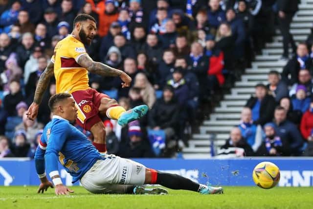 Kaiyne Woolery scores Motherwell's second goal in the 2-2 draw at Ibrox despite the efforts of Rangers captain James Tavernier. (Photo by Craig Williamson / SNS Group)