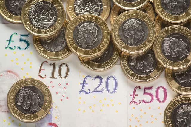 File photo dated 26/01/18 of UK five pound, ten pound, twenty pound and fifty pound notes with one pound coins, as the Scottish Government is not on track to meet its child poverty targets, a new report shows.