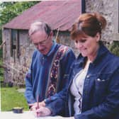 Group members Avril Bryson and Ian Wallace pictured doing a measured survey of Blackcastle Farm; the project would not have been possible without Marshall Watson's connections.