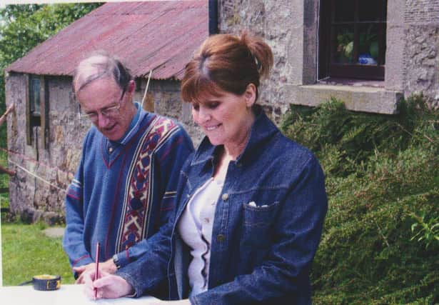 Group members Avril Bryson and Ian Wallace pictured doing a measured survey of Blackcastle Farm; the project would not have been possible without Marshall Watson's connections.