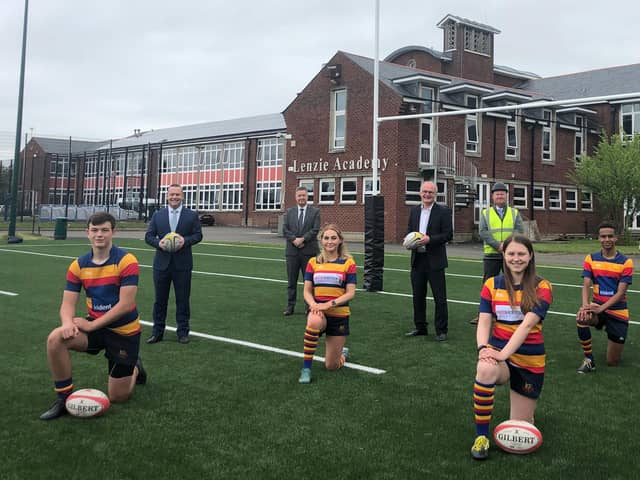 A brand new 3G rugby pitch at Lenzie Academy - the first of its kind in East Dunbartonshire - is being hailed as a game changer by pupils.
Pupils (l-r): Drew, Helena, Juliet & Kiendi
Others: (l-r): Joint Council Leader Andrew Polson, Head teacher Brian Paterson, Joint Council Leader Vaughan Moody, Joe Canavan (Allsports) and Jim Graham (Council Assets Team)
