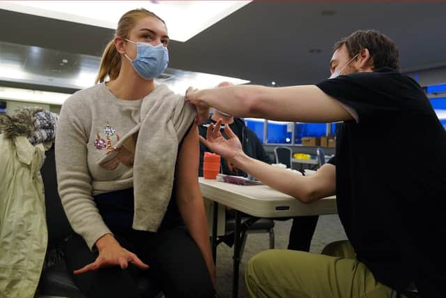 Reece Maclean is given a vaccination at a COVID-19 booster vaccination centre at Hampden Park vaccination centre in Glasgow.