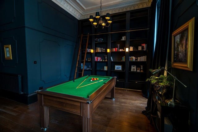 The drawing room also includes this space, with a library wall and pool table.