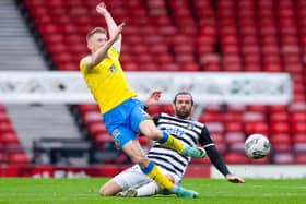 Raith Rovers defender Liam Dick being tackled by Queen's Park's Cillian Sheridan