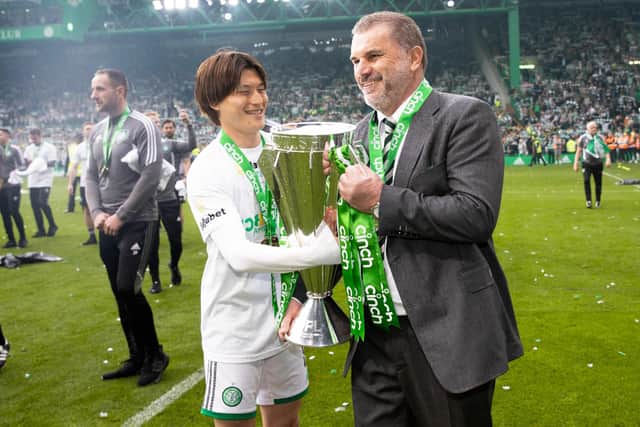 Celtic's Kyogo Furuhashi and Ange Postecoglou with the Premiership trophy at full time.