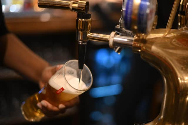 A pint being poured in a pub. 