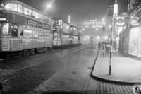Trams in Argyle Street with neon signs, 1960s.