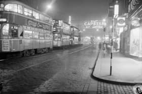 Trams in Argyle Street with neon signs, 1960s.
