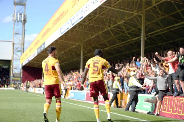 Ricki Lamie and Bevis Mugabi celebrate in front of jubilant 'Well fans after Mugabi goal