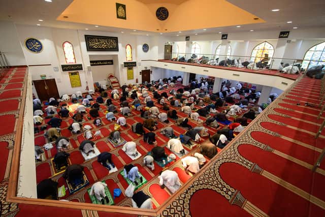 Muslims gather to perform the Eid Al-Fitr prayer, which marks the end of the holy month of Ramadan. (Photo by OLI SCARFF/AFP via Getty Images)