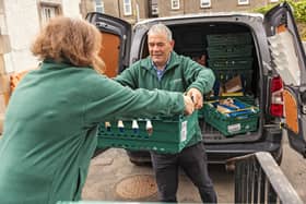 Volunteers unpack food donations at a food bank