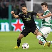 Celtic's Matt O'Riley challenges Eden Hazard of Real Madrid during the Champions League match at Parkhead on Tuesday. (Photo by Alan Harvey / SNS Group)