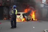 A car burns on Parliament Road, in Middlesbrough, during an anti-immigration riot. Credit: Owen Humphreys/PA Wire