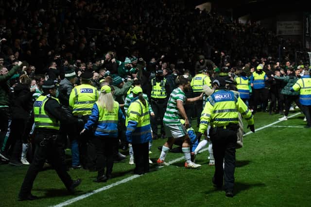 Celtic fans spill on to the pitch after Anthony Ralston's winning goal in the 97th minute. (Photo by Craig Foy / SNS Group)