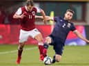 Scotland's Stephen O'Donnell and Austria's Louis Schaub vying for possession last week at the Ernst Happel Stadion in Vienna (Photo: Christian Hofer/Getty Images)