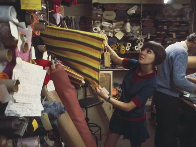 British fashion designer Mary Quant pictured selecting rolls of fabric from a fabric store and warehouse in London to create samples for a future collection in 1967. (Photo by Rolls Press/Popperfoto via Getty Images/Getty Images)