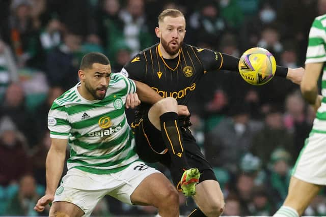 Celtic's Cameron Carter-Vickers (left) tussles with Motherwell's Kevin van veen during a Cinch premiership match between Celtic and Motherwell at Celtic Park.