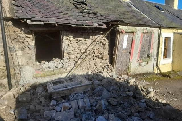 The wall collapsed onto the roadway blocking access for the other homes