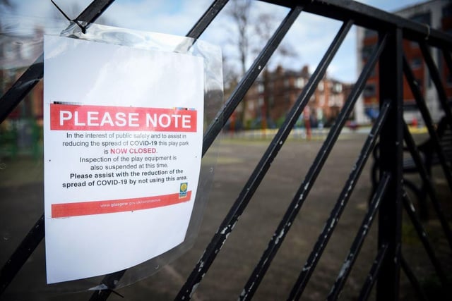 A notice warns parents that a play park is closed-off to the public due to the ongoing Covid-19 pandemic, in Queen's Park.