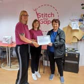 DELIGHTED: Amanda and Patricia, founders of Stitch the Gap, receive a framed motion from Rona Mackay MSP after their success at the EDGE Awards