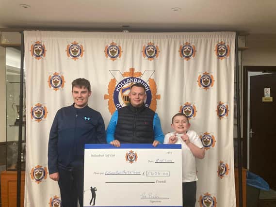 Hollandbush captain Aaron McIntyre at cheque presentation with youngsters Craig Johnston and Jamie Brown