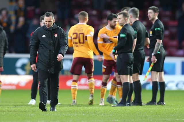 Stephen Glass trudges off just a few hours before being sacked as Dons boss