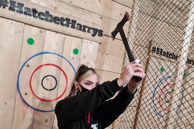 Abbie Young can show the men a thing or two about axe throwing at Hatchett Harry's!
