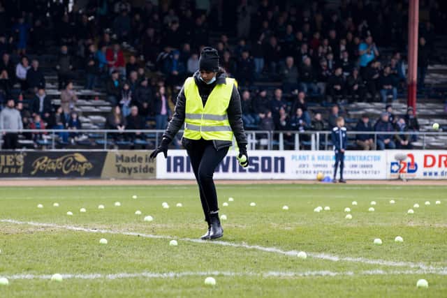 The game is stopped as Rangers fan throw tennis balls onto the pitch to protest the Old Firm friendly in Australia during the match against Dundee at Dens Park. (Photo by Alan Harvey / SNS Group)