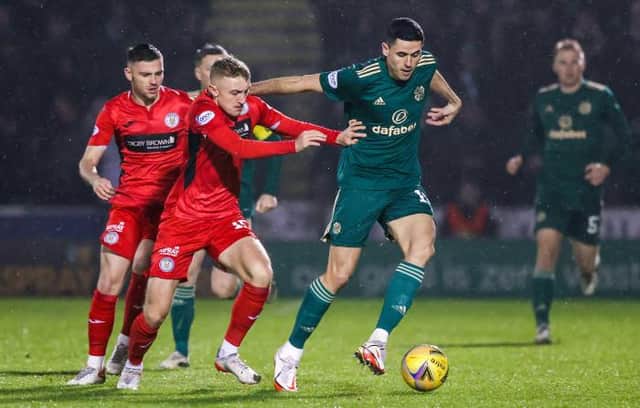 PAISLEY, SCOTLAND - DECEMBER 22: Dylan Reid and Tom Rogic in action during a Cinch Premiership match between St. Mirren and Celtic at SMiSA Stadium, on December 22, 2021, in Paisley, Scotland.  (Photo by Craig Williamson / SNS Group)