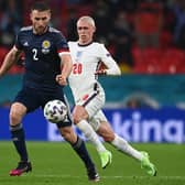 Scotland ace Stephen O'Donnell is pictured with England star Phil Foden during Friday's clash (Pic by Getty Images)