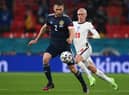 Scotland ace Stephen O'Donnell is pictured with England star Phil Foden during Friday's clash (Pic by Getty Images)