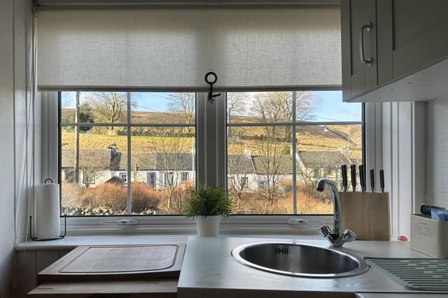 One of the kitchen's best features is the stunning view over the village and hills beyond which is almost enough to make you want to put the rubber gloves on – almost!