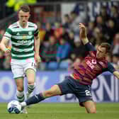 Connor Randall tackles Celtic's David Turnbull - but it was a later challenge on Jota that resulted in a fractured leg for the Ross County player.  (Photo by Craig Williamson / SNS Group)