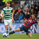 Connor Randall tackles Celtic's David Turnbull - but it was a later challenge on Jota that resulted in a fractured leg for the Ross County player.  (Photo by Craig Williamson / SNS Group)