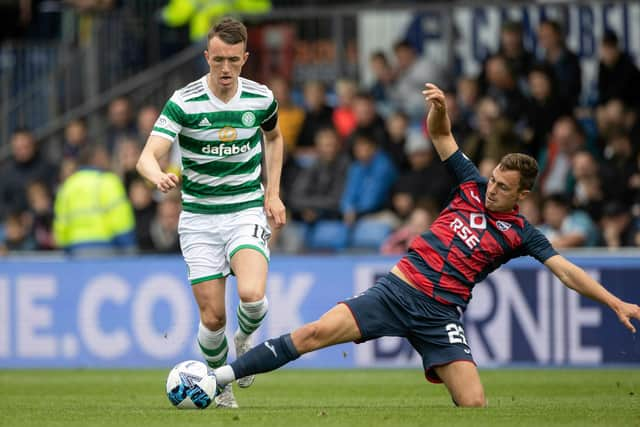 Connor Randall tackles Celtic's David Turnbull - but it was a later challenge on Jota that resulted in a fractured leg for the Ross County player.  (Photo by Craig Williamson / SNS Group)