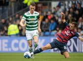 Connor Randall tackles Celtic's David Turnbull - but it was a later challenge on Jota that resulted in a fractured leg for the Ross County player.  (Photo by Craig Williamson / SNS Group)