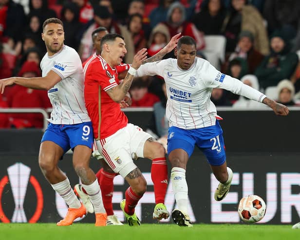 Angel Di Maria of Benfica is challenged by Rangers' Cyriel Dessers and Dujon Sterling