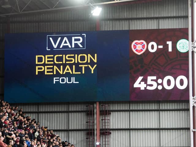 After VAR intervention, referee Nick Walsh awards a penalty for a foul in the box by Celtic's Cameron Carter-Vickers on Hearts' Cammy Devlin. (Photo by Mark Scates / SNS Group)
