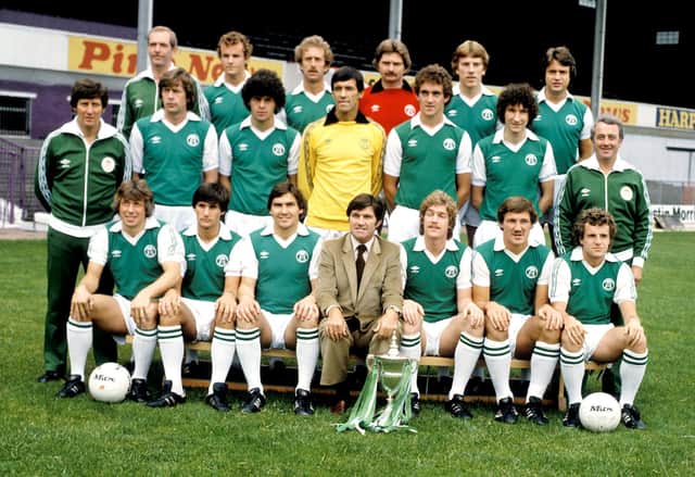 Bertie Auld and the Hibs team pose with the First Division trophy at Easter Road