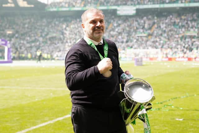 Celtic manager Ange Postecoglou celebrates with the Premiership trophy.
