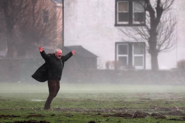 A man savours the heavy rain in Helensburgh, Argyll and Bute, last Friday (Picture: Jeff J Mitchell/Getty Images)