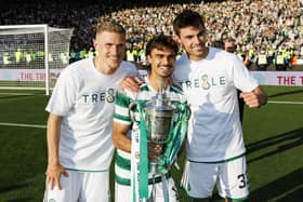 Celtic's Carl Starfelt (L) Jota and Matt O'Riley (R) with the Scottish Cup last season.